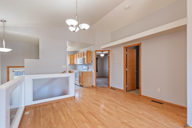 kitchen with ceiling fan with notable chandelier, decorative light fixtures, lofted ceiling, white electric range oven, and light hardwood / wood-style flooring