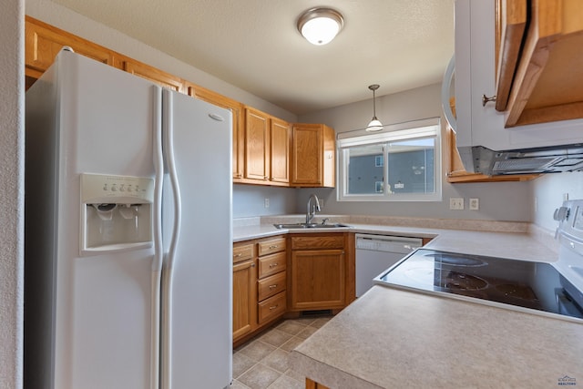 kitchen with sink, pendant lighting, white appliances, and light tile patterned floors