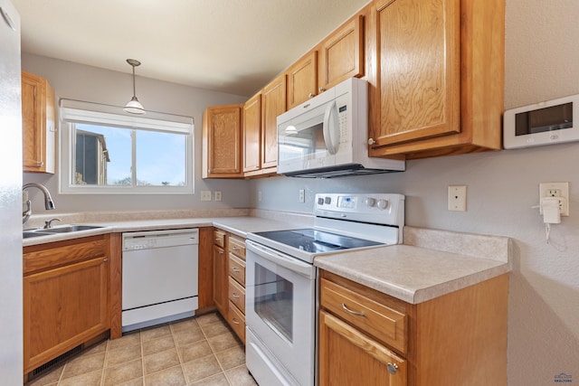 kitchen with sink, pendant lighting, and white appliances