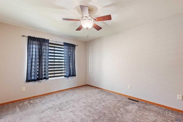 carpeted spare room with ceiling fan