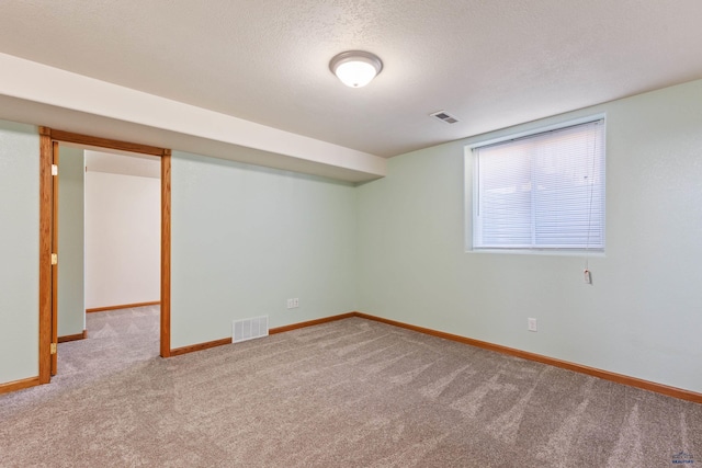 interior space featuring carpet floors and a textured ceiling