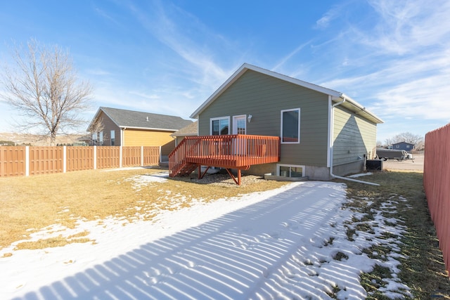 snow covered property featuring a wooden deck