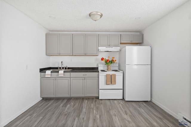 kitchen with sink, white appliances, gray cabinets, light hardwood / wood-style floors, and a textured ceiling