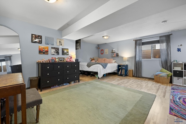 bedroom featuring wood-type flooring and multiple windows