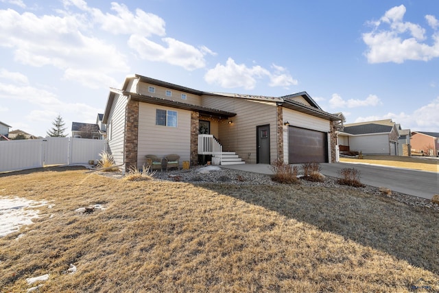 ranch-style house with a garage and a front lawn