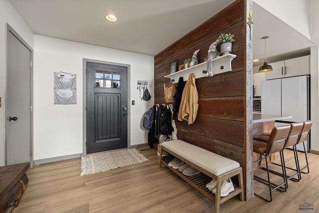 mudroom with light hardwood / wood-style floors