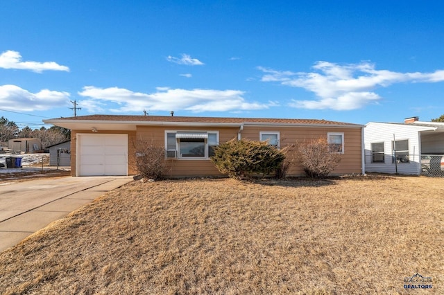 ranch-style house featuring a garage and a front lawn