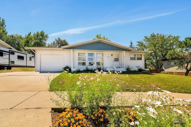 ranch-style house featuring a garage and a front lawn