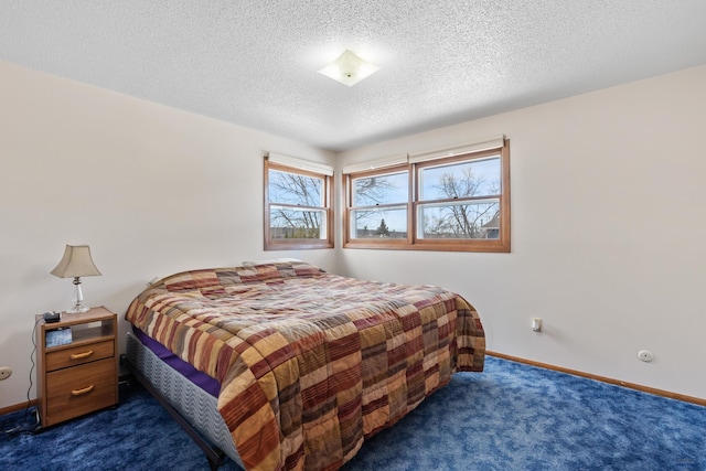 carpeted bedroom with a textured ceiling