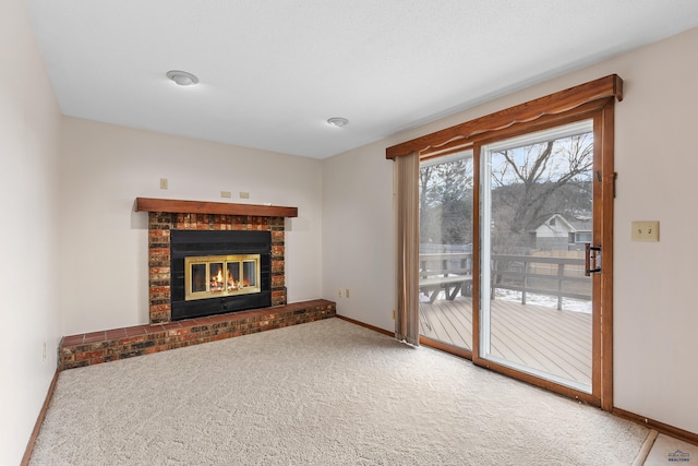 unfurnished living room featuring a brick fireplace and carpet