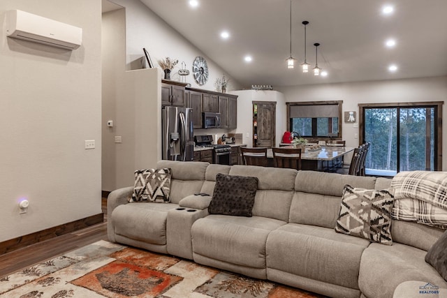 23232 Clear Creek Rd, Rapid City, SD 57702 - living room featuring a wall mounted AC, high vaulted ceiling, and light hardwood / wood-style flooring