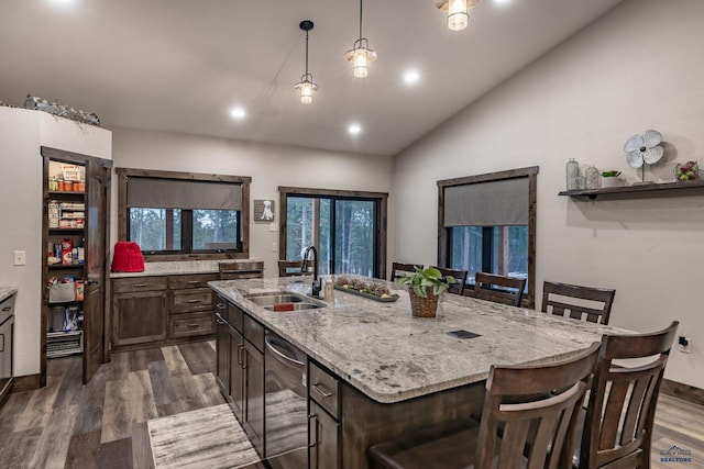 23232 Clear Creek Rd, Rapid City, SD 57702 - kitchen with sink, light stone countertops, an island with sink, dark hardwood / wood-style flooring, and decorative light fixtures