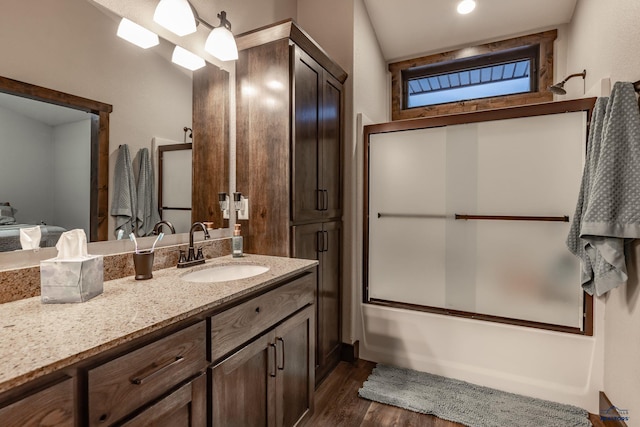 23232 Clear Creek Rd, Rapid City, SD 57702 - bathroom featuring vanity, hardwood / wood-style flooring, and combined bath / shower with glass door