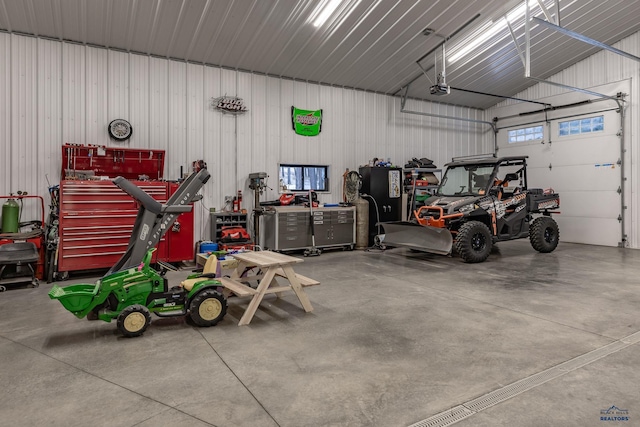 23232 Clear Creek Rd, Rapid City, SD 57702 - garage featuring a garage door opener and a workshop area