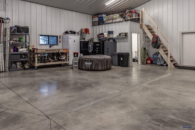 23232 Clear Creek Rd, Rapid City, SD 57702 - garage featuring black fridge and wooden walls