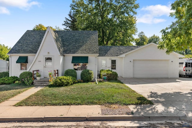 view of front of property featuring a garage and a front yard