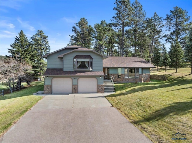 split level home featuring a garage, a front lawn, and covered porch