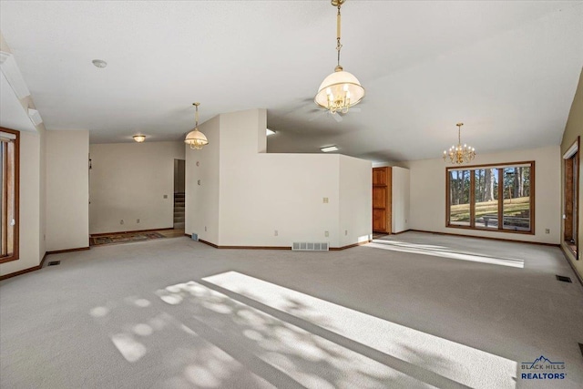 unfurnished living room with light colored carpet and a chandelier