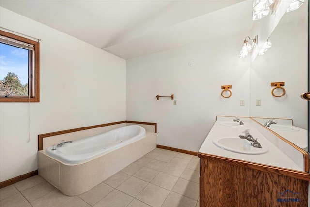 bathroom with tile patterned flooring, a bathing tub, and vanity