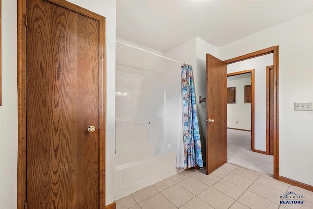 bathroom with shower / bath combo and tile patterned floors