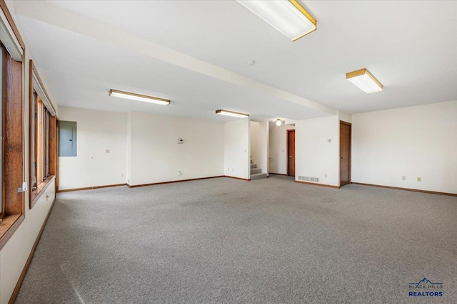 carpeted empty room with electric panel