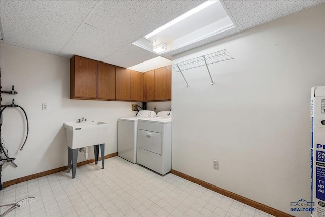 washroom featuring cabinets and washer and dryer