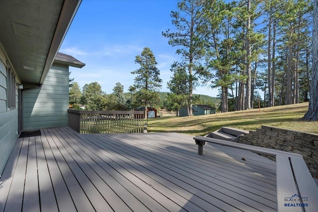 wooden deck with a lawn