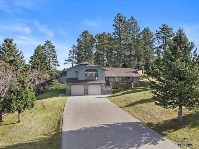 tri-level home featuring a garage and a front yard