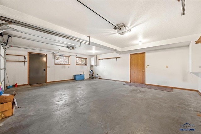 garage with a garage door opener and electric panel