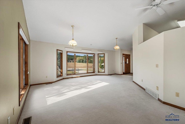 unfurnished living room with lofted ceiling, light carpet, and ceiling fan