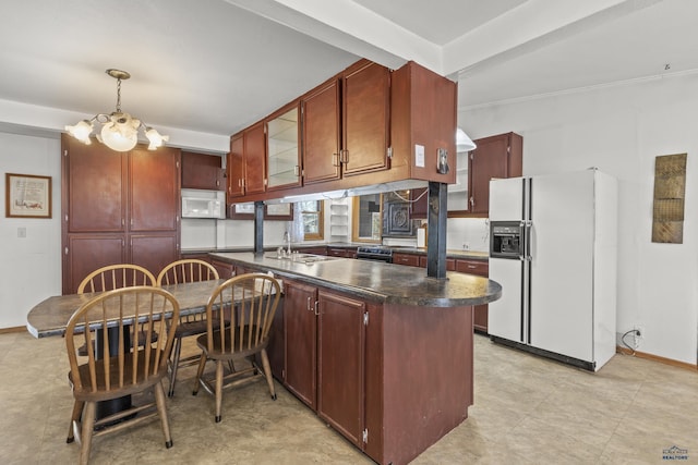 318 4th Ave, Wall, SD 57790 - kitchen featuring pendant lighting, sink, white appliances, and kitchen peninsula