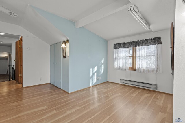 318 4th Ave, Wall, SD 57790 - unfurnished room with a baseboard heating unit, light hardwood / wood-style flooring, and lofted ceiling with beams