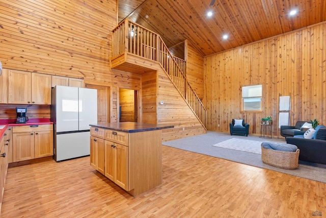 kitchen with white refrigerator, wooden ceiling, and light brown cabinets