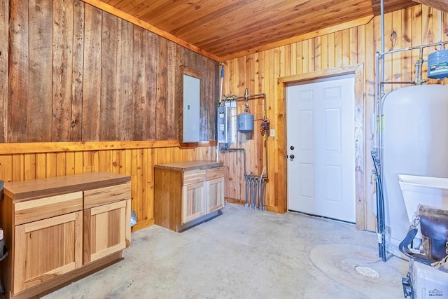 miscellaneous room with wooden ceiling, electric panel, and wood walls