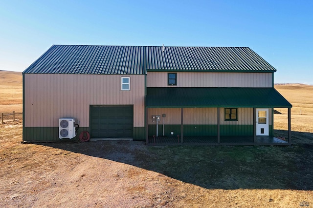 view of property featuring a garage and ac unit