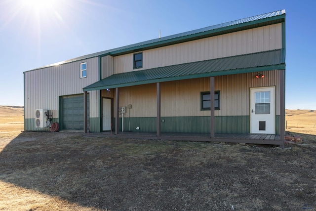 back of property with a garage