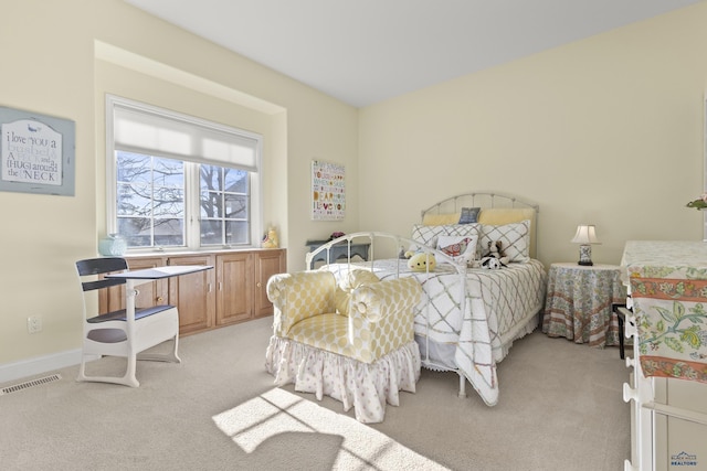 bedroom featuring light carpet