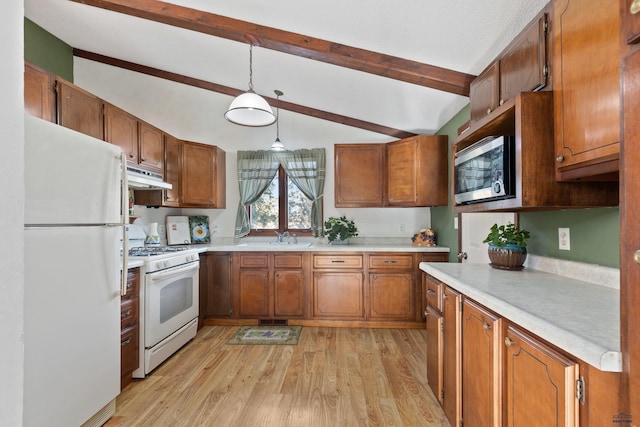 kitchen featuring sink, decorative light fixtures, lofted ceiling with beams, light wood-type flooring, and white appliances