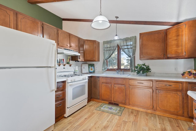 kitchen featuring pendant lighting, lofted ceiling with beams, sink, white appliances, and light hardwood / wood-style flooring