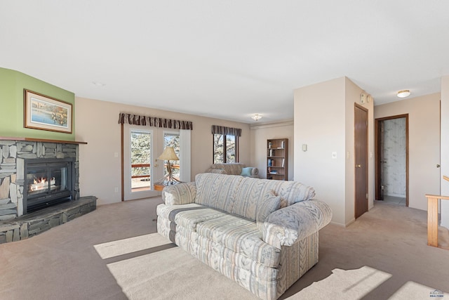 living room with light colored carpet and a stone fireplace