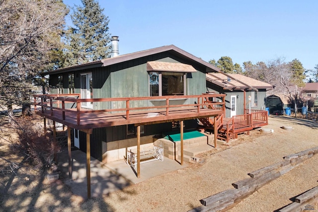 back of house with a patio area and a deck