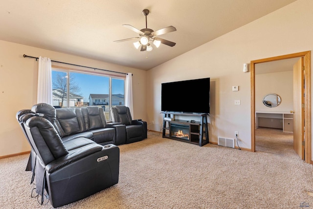 living room with ceiling fan, light colored carpet, and lofted ceiling