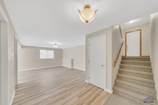 stairway with hardwood / wood-style floors