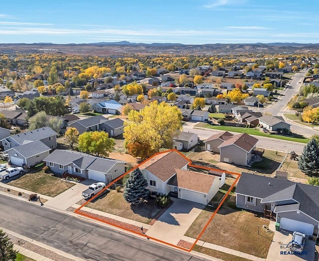 birds eye view of property with a mountain view