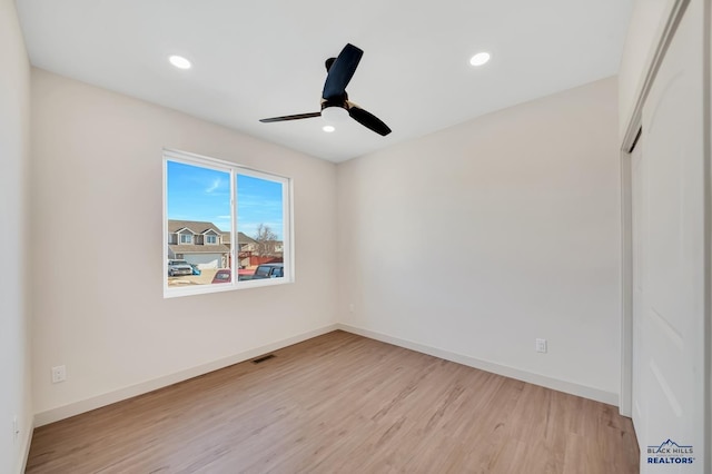 spare room with ceiling fan and light hardwood / wood-style flooring