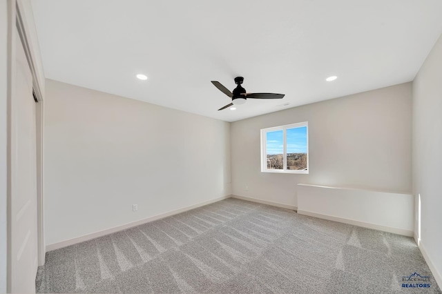 empty room with ceiling fan and light carpet