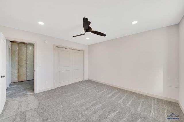 unfurnished bedroom featuring carpet flooring, ceiling fan, and a closet