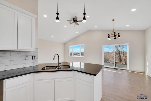 kitchen with pendant lighting, sink, and white cabinets