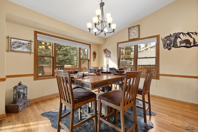 369 Deegan Dr, Hill City, SD 57745 - dining room featuring lofted ceiling, an inviting chandelier, and light wood-type flooring