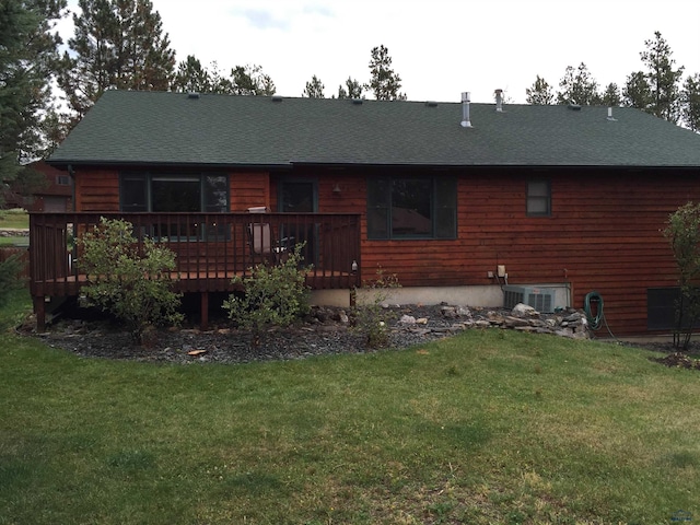 369 Deegan Dr, Hill City, SD 57745 - rear view of property featuring a wooden deck, central AC unit, and a yard